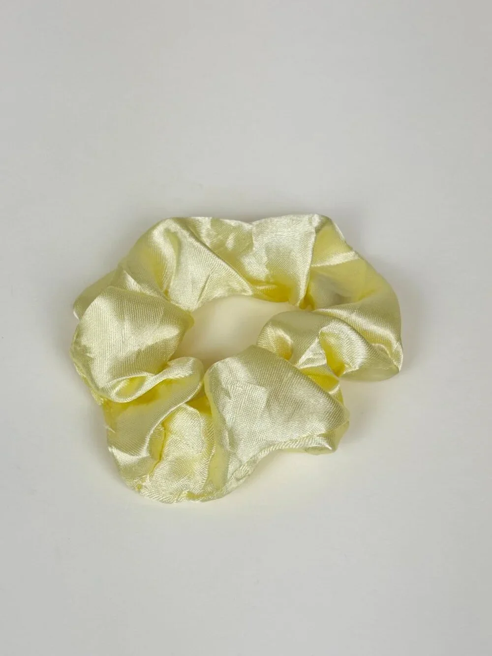 Pale yellow satin scrunchie. New without tags. Never used. Unbranded